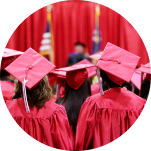  students wearing red graduation caps and gowns